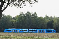 (FILES) In this file photo taken on September 16, 2018 A hydrogen-powered train, by French train maker Alstom, drives near Bremervoerde, Germany, as it enters service on September 16, 2018. - Germany inaugurates a rail line running entirely on hydrogen on August 24, 2022, a "world first" and a major step forward for the decarbonisation of rail, despite the supply challenges posed by this innovative technology. (Photo by Patrik STOLLARZ / AFP)
