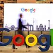 (FILES) In this file photo taken on January 22, 2019 a technician passes by a logo of US internet search giant Google during the opening day of a new Berlin office of Google in Berlin. - Google parent Alphabet reported a rare drop in revenue and profit on July 30, 2020, in a quarterly update that nonetheless topped market expectations. (Photo by Tobias SCHWARZ / AFP)
