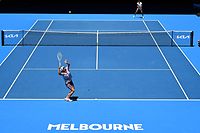 Poland's Iga Swiatek (bottom L) serves to Madison Keys of the US (top R) during a practice session ahead of the Australian Open tennis tournament in Melbourne on January 11, 2023. (Photo by William WEST / AFP) / -- IMAGE RESTRICTED TO EDITORIAL USE - STRICTLY NO COMMERCIAL USE --