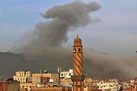 (FILES) This file photo taken on June 16, 2020 shows smoke billowing following an airstrike by the Saudi-led coalition in the Huthi-controlled Yemeni capital Sanaa. - Saudi Arabia and Iran's surprise rapprochement is no "magic wand" for Yemen, analysts say, warning there are no easy solutions for the complex conflict in the Arab world's poorest country. (Photo by MOHAMMED HUWAIS / AFP)