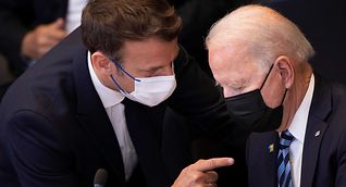 Macron (left) in discussion with US President Joe Biden before a NATO meeting in Brussels on Monday