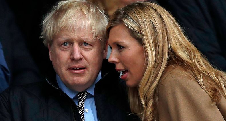 (FILES) In this file photo taken on March 07, 2020 Britain's Prime Minister Boris Johnson (L) with his partner Carrie Symonds attend the Six Nations international rugby union match between England and Wales at the Twickenham, west London - Britain's Prime Minister Boris Johnson and his partner Carrie Symonds have named their son Wilfred Lawrie Nicholas Johnson, in a tribute to their grandfathers and the doctors who helped save the Prime Minister's life. (Photo by ADRIAN DENNIS / AFP)