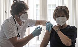 08.04.2021, Berlin: Der Berliner Hausarzt Karl Schorn impft seine Patientin Nicole Brusselaers mit dem Biontech-Impfstoff gegen das Coronavirus. Foto: Paul Zinken/dpa-Zentralbild/dpa +++ dpa-Bildfunk +++