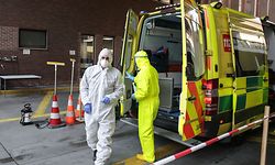 A Belgian firefighter wearing protective equipment prepares to enter an ambulance to transfer a patient infected with the novel coronavirus COVID-19 to the hospital in Brussels, on April 09, 2020. (Photo by Aris Oikonomou / AFP)