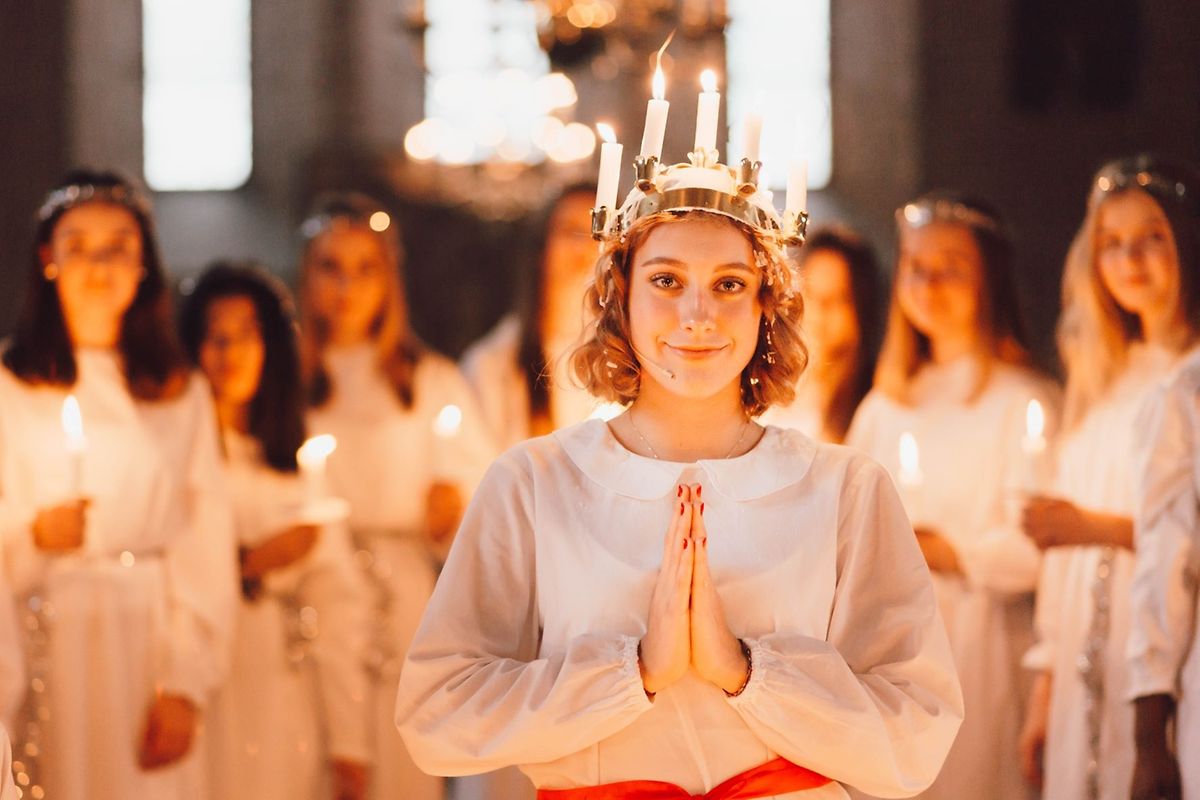 Santa Lucia wears a crown of candles on her head 