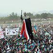 (FILES) In this file photo taken on July 09, 2011 A large crowd wave the flag of the new Republic of South Sudan during the unveiling of a statue of late South Sudan rebel leader and first Vice-President John Garang during a ceremony celebrating the independence of South Sudan from Sudan in the capital Juba. - South Sudan, which marks a decade of independence on July 9, is the world's youngest country and also one of the poorest, crippled by a devastating civil war that has left tens of thousands of people dead. (Photo by Roberto SCHMIDT / AFP)