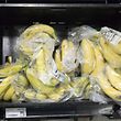 Bananas packaged in plastic are pictured for sale at a branch of Asda in south London, on January 10, 2018. / AFP PHOTO / Justin TALLIS