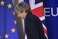 British Prime Minister Theresa May walks after holding a press conference on March 22, 2019, on the first day of an EU summit focused on Brexit, in Brussels. - European Union leaders meet in Brussels on March 21 and 22, for the last EU summit before Britain's scheduled exit of the union. (Photo by Emmanuel DUNAND / AFP)