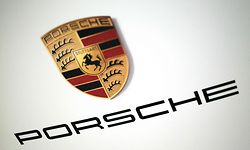 The logo of German car producer Porsche AG is pictured on the sidelines of the launch of the company's initial public offering (IPO) at the Frankfurt Stock Exchange in Frankfurt, western Germany, on September 29, 2022. - Luxury sports carmaker Porsche will on September 29, 2022 race onto the Frankfurt stock exchange in what is set to be one of Europe's biggest listings in years, seeking to defy recent market turbulence. Parent company Volkswagen hopes the flotation will raise up to 9.4 billion euros (USD 9.2 billion) and are targeting a valuation of up to 75 billion euros for Porsche. (Photo by Daniel ROLAND / AFP)