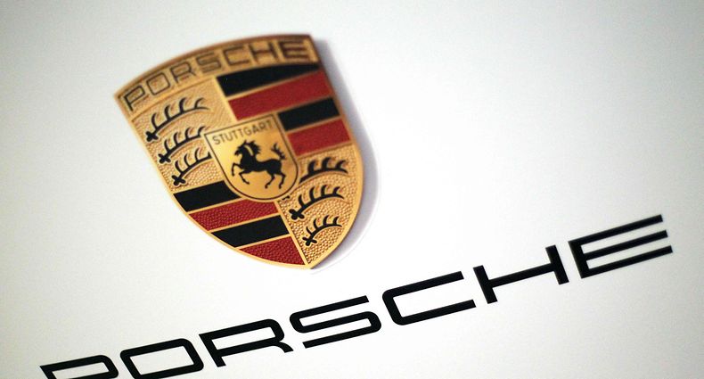 The logo of German car producer Porsche AG is pictured on the sidelines of the launch of the company's initial public offering (IPO) at the Frankfurt Stock Exchange in Frankfurt, western Germany, on September 29, 2022. - Luxury sports carmaker Porsche will on September 29, 2022 race onto the Frankfurt stock exchange in what is set to be one of Europe's biggest listings in years, seeking to defy recent market turbulence. Parent company Volkswagen hopes the flotation will raise up to 9.4 billion euros (USD 9.2 billion) and are targeting a valuation of up to 75 billion euros for Porsche. (Photo by Daniel ROLAND / AFP)