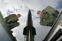 (FILES) Photo taken on October 5, 2005 of Russian soldiers sitting on the launcher of Tochka-M (Point-M), a short range missile, which has a range of about 44 miles (70 kilometres) prior its launch at the military training ground outside the Russian enclave of Kaliningrad. Russia denied that it had made any kind of secret deal with the United States in exchange for Washington shifting its position on missile defence, a foreign ministry spokesman said on September 17, 2009.<br />AFP PHOTO