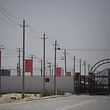 (FILES) This file photo taken on May 31, 2019 shows Chinese flags on a road leading to a facility believed to be a re-education camp where mostly Muslim ethnic minorities are detained, on the outskirts of Hotan in China's northwestern Xinjiang region. - China on January 20, 2021 dismissed Washington's declaration that Beijing was committing genocide against Uighurs and other minorities as "outrageous lies" and "poison". (Photo by GREG BAKER / AFP)