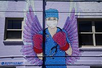 DENVER, CO - APRIL 14: A mural depicting a medical worker with a mask covering her mouth and nose, wearing boxing gloves and angel-like wings on her back is seen on April 14, 2020 in downtown Denver, United States. The World Health Organization declared the coronavirus (COVID-19) a global pandemic on March 11th. Denver county has had the most COVID-19 cases in the state at 1,346 to date.   Rick T. Wilking/Getty Images/AFP
== FOR NEWSPAPERS, INTERNET, TELCOS & TELEVISION USE ONLY ==