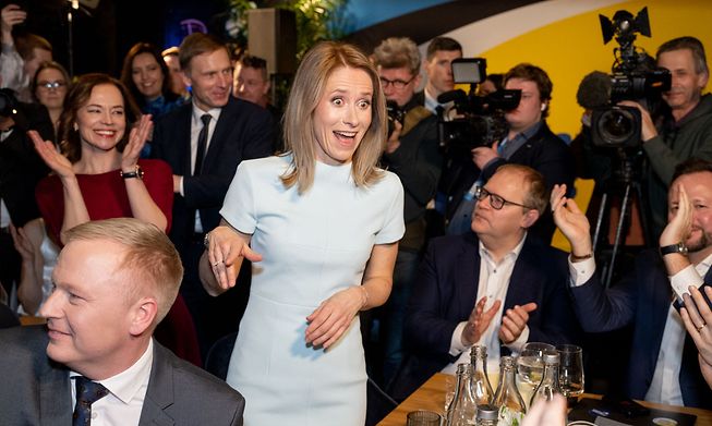 Estonian Prime Minister Kaja Kallas (C) reacts after the results of e-votes were announced in Tallinn, Estonia