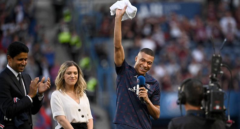Paris Saint-Germain's French forward Kylian Mbappe addresses supporters after the announcement he staying at PSG until 2025 before the French L1 football match between Paris Saint-Germain (PSG) and Metz at the Parc des Princes stadium in Paris on May 21, 2022. (Photo by Anne-Christine POUJOULAT / AFP)