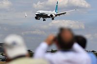 (FILES) In this file photo taken on July 16, 2018 Visitors watch as a Boeing 737 Max lands after an air display during the Farnborough Airshow, south west of London. - Britain's aviation regulator on March 12, 2019, banned Boeing 737 MAX aircraft from the country's airspace following a deadly plane crash in Ethiopia, mirroring a decision taken by other nations. The UK Civil Aviation Authority said in a statement headlined "Boeing 737 MAX Aircraft" that "as a precautionary measure" it had decided "to stop any commercial passenger flights from any operator arriving, departing or overflying UK airspace". (Photo by BEN STANSALL / AFP)