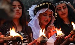 Iraqi Yazidi women hold candles outside the Temple of Lalish, in a valley near the Kurdish city of Dohuk about 430 kilometres northwest of the capital Baghdad, on April 16, 2019, during a ceremony marking the Yazidi New Year. - The Yazidis, who number about 1.6 million, commemorate the arrival of light into the world during the new year celebrations. (Photo by SAFIN HAMED / AFP)