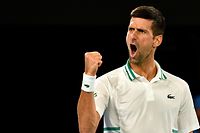 (FILES) This file photo taken on February 18, 2021 shows Serbia's Novak Djokovic reacting after a point against Russia's Aslan Karatsev during their men's singles semi-final match on day 11 of the Australian Open tennis tournament in Melbourne. - World number one Novak Djokovic won a stunning victory on January 10, 2022 over the Australian government, overturning the cancellation of his visa on Covid-19 health grounds, and ending his detention. (Photo by Paul CROCK / AFP) / -- IMAGE RESTRICTED TO EDITORIAL USE - STRICTLY NO COMMERCIAL USE --
