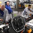 ZWICKAU, GERMANY - FEBRUARY 25: Workers assemble the lower body that includes the battery and charging port of an ID.3 electric car on the assembly line at the Volkswagen factory on February 25, 2020 in Zwickau, Germany.  Volkswagen is gradually revving up ID.3 production at the Zwickau plant from a current 110 per day to an eventual 1,500.  The Zwickau plant is the first of its many factories that Volkswagen is retooling from producing combustion engine cars to only producing electric cars.  Sales of the ID.3 will begin this summer.  (Photo by Sean Gallup/Getty Images)