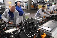 ZWICKAU, GERMANY - FEBRUARY 25: Workers assemble the lower body that includes the battery and charging port of an ID.3 electric car on the assembly line at the Volkswagen factory on February 25, 2020 in Zwickau, Germany. Volkswagen is gradually revving up ID.3 production at the Zwickau plant from a current 110 per day to an eventual 1,500. The Zwickau plant is the first of its many factories that Volkswagen is retooling from producing combustion engine cars to only producing electric cars. Sales of the ID.3 will begin this summer.    (Photo by Sean Gallup/Getty Images)