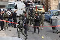Israeli security forces and emergency service personnel gather at a cordoned-off area in Jerusalem's predominantly Arab neighbourhood of Silwan, where an assailant reportedly shot and wounded two people, on January 28, 2023. - An assailant shot and wounded two people in east Jerusalem today, Israeli medics said, hours after a Palestinian gunman killed seven outside a synagogue in one of the deadliest such attacks in years. Police said the suspect was "neutralised" following the gun attack in the Silwan neighbourhood, just outside Jerusalem's old, walled city. (Photo by AHMAD GHARABLI / AFP)