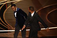 TOPSHOT - US actor Will Smith (R) slaps US actor Chris Rock onstage during the 94th Oscars at the Dolby Theatre in Hollywood, California on March 27, 2022. (Photo by Robyn Beck / AFP)
