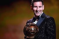 Paris Saint-Germain's Argentine forward Lionel Messi reacts after being awarded the the Ballon d'Or award during the 2021 Ballon d'Or France Football award ceremony at the Theatre du Chatelet in Paris on November 29, 2021. (Photo by FRANCK FIFE / AFP)