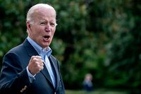 TOPSHOT - US President Joe Biden answers a shouted question from a reporter while walking to Marine One on the South Lawn of the White House in Washington, DC, on August 7, 2022, as he travels to Rehoboth Beach, Delaware. (Photo by Stefani Reynolds / AFP)
