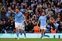 Manchester City's Portuguese midfielder Bernardo Silva (R) celebrates scoring the opening goal during the UEFA Champions League second leg semi-final football match between Manchester City and Real Madrid at the Etihad Stadium in Manchester, north west England, on May 17, 2023. (Photo by Oli SCARFF / AFP)