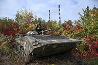A ukrainian soldier sits atop a BMP infantry fighting vehicle in Kramatorsk, eastern Ukraine, on October 2, 2022, amid the Russian invasion of Ukraine. (Photo by Juan BARRETO / AFP)