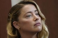 Actor Amber Heard testifies at Fairfax County Circuit Court during a defamation case against her by ex-husband, actor Johnny Depp, in Fairfax, Virginia, on May 4, 2022. - US actor Johnny Depp sued his ex-wife Amber Heard for libel in Fairfax County Circuit Court after she wrote an op-ed piece in The Washington Post in 2018 referring to herself as a "public figure representing domestic abuse." (Photo by ELIZABETH FRANTZ / POOL / AFP)