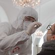 (FILES) In this file photo taken on February 4, 2021 a health worker takes a coronavirus antigen rapid test swab at the new coronavirus test center in the Orangery of the Schoenbrunn Palace as Vienna expands its capacities for the rapid antigen test, amid the ongoing Covid-19 pandemic. - While Austria has struggled to contain the second wave of the coronavirus pandemic, it is fast emerging as a world leader in testing as a way of opening schools and businesses. (Photo by ALEX HALADA / AFP)