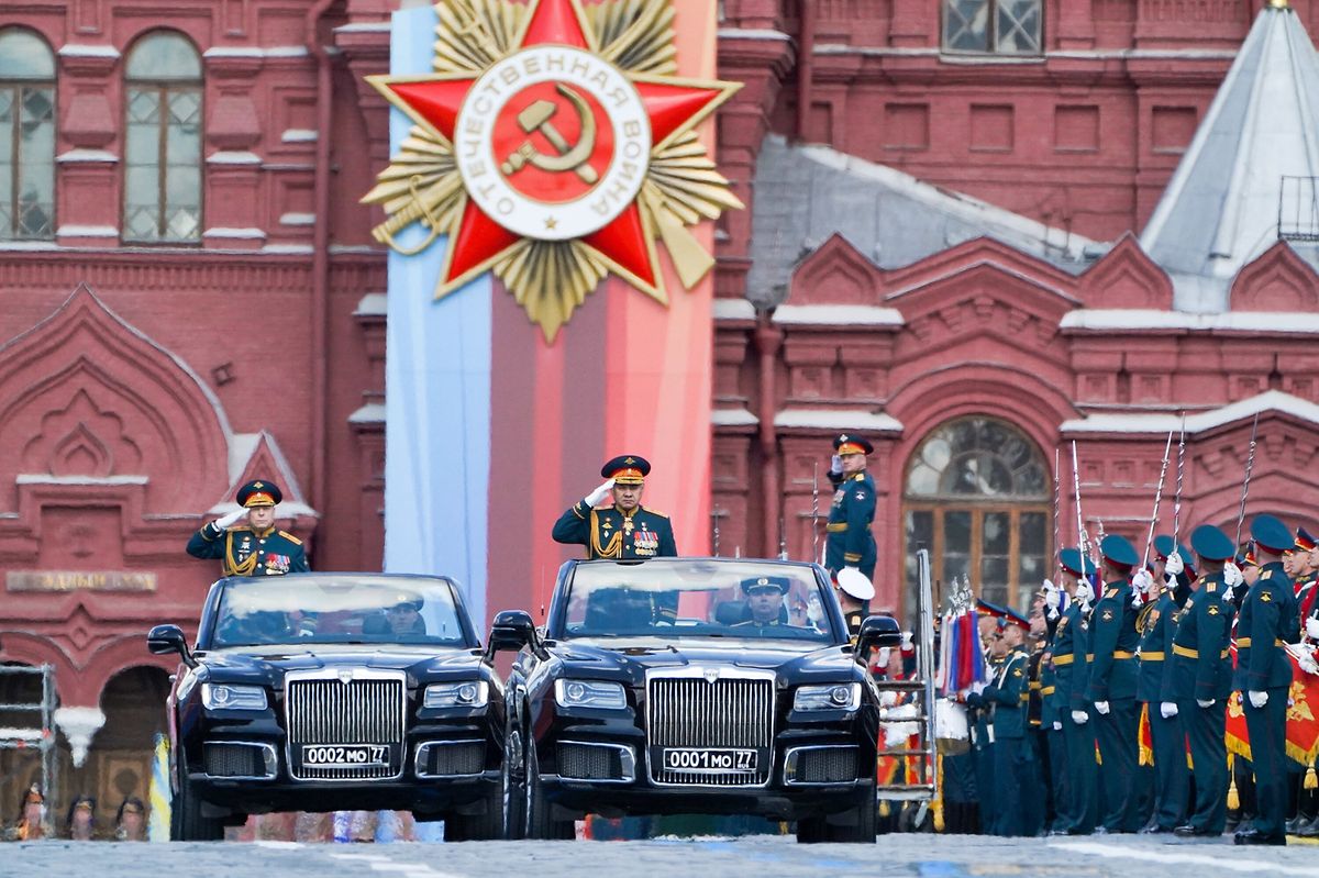Russian Defence Minister Sergei Shoigu salutes to soldiers as he is driven along Red Square during the Victory Day military parade in central Moscow