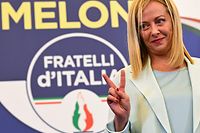 TOPSHOT - Leader of Italian far-right party "Fratelli d'Italia" (Brothers of Italy), Giorgia Meloni flashes a victory sign as she acknowledges the audience after she delivered an address at her party's campaign headquarters overnight on September 26, 2022 in Rome, after the country voted in a legislative election. - Far-right leader Giorgia Meloni won big in Italian elections on September 25, the first projections suggested, putting her eurosceptic populists on course to take power at the heart of Europe. (Photo by Andreas SOLARO / AFP)
