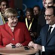 French President Francois Hollande and German Chancellor Angela Merkel participate in the conclusion of exchanges of the "Caf� du Monde" organized by the Franco-German Youth Office (OFAJ) on April 07, 2016 in Metz, eastern France, as part of a Franco-German cabinet meeting.  / AFP PHOTO / POOL / FREDERICK FLORIN