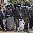 A soldier (C) carries a sniper rifle during a demonstration against the military coup where security forces fired on protesters in Mandalay on February 20, 2021. (Photo by STR / AFP)