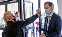 Belgian Prime Minister Alexander De Croo gets his temperature checked during a visit to the vaccination village setup in the Heysel site of the Brussels Expo exhibition halls in Brussels on April 15, 2021. (Photo by OLIVIER HOSLET / BELGA / AFP) / Belgium OUT