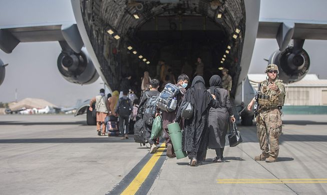 Families boarded a US Air Force Boeing C-17 Globemaster III during their evacuation from Kabul, Afghanistan, on Monday.