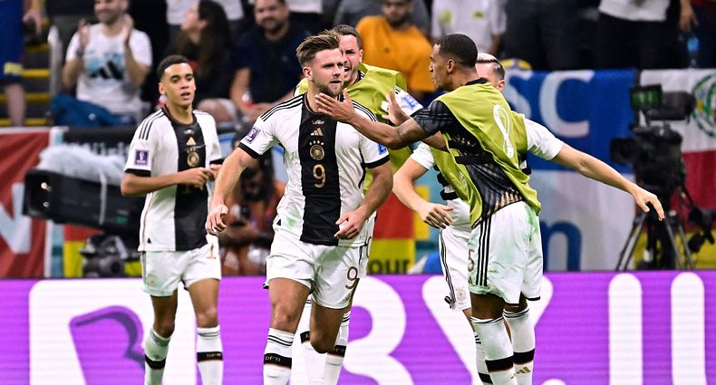 Germany's forward #09 Niclas Fullkrug (2nd L) celebrates with teammantes after scoring his team's first goal during the Qatar 2022 World Cup Group E football match between Spain and Germany at the Al-Bayt Stadium in Al Khor, north of Doha on November 27, 2022. (Photo by JAVIER SORIANO / AFP)