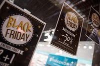 A picture shows signs price markdown signs for Black Friday sales in a shop in Caen, northwestern France, on November 27, 2019. - Black Friday is a sales offer originating from the US where retailers slash prices on the day after the Thanksgiving holiday. (Photo by Sameer Al-DOUMY / AFP)