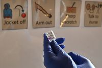 A health worker prepares a dose of the AstraZeneca/Oxford Covid-19 vaccine at a temporary vaccine centre set up at City Hall in Hull, northeast England on February 10, 2021. (Photo by Paul ELLIS / AFP)