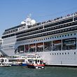 TOPSHOT - Rescuing boats of the Carabinieri Police (Front) and the port's fire rescue service (2ndL) assist the damaged River Countess tourist boat (Rear L) after it was hit early on June 2, 2019 by the MSC Opera cruise ship (R) that lost control as it was coming in to dock in Venice, Italy. - Tourists on land could be seen running away as the MSC Opera scraped along the dockside, its engine blaring, before knocking into the River Countess tourist boat. (Photo by Andrea PATTARO / AFP)
