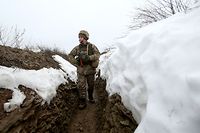 An Ukrainian Military Forces serviceman walks on a trench on the frontline with Russia-backed separatists near Luganske village, in Donetsk region on January 11, 2022. - Ukraine said on January 11, 2022 it welcomes "efforts" by the West and Russia to ease tensions over Ukraine after a week of high-stakes diplomacy kicked-off in Geneva this week. (Photo by Anatolii STEPANOV / AFP)
