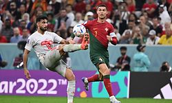 Portugal's forward #07 Cristiano Ronaldo (R) fights for the ball with Switzerland's defender #18 Eray Comert during the Qatar 2022 World Cup round of 16 football match between Portugal and Switzerland at Lusail Stadium in Lusail, north of Doha on December 6, 2022. (Photo by Fabrice COFFRINI / AFP)
