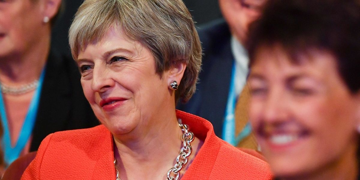 Britain's Prime Minister Theresa May reacts as she listens from her seat in the audience in the main hall on the first day of the Conservative Party Conference 2018 at the International Convention Centre in Birmingham, on September 30, 2018. - Prime Minister Theresa May gathered her party for its annual conference, under immediate attack from leading rival Boris Johnson over her strategy for pulling Britain out of the European Union. (Photo by Ben STANSALL / AFP)
