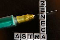 This illustration photo taken on April 8, 2021 shows an injection needle next to letters forming the name of the vaccine against the coronavirus (Covid-19) AstraZeneca in Salzburg, Austria. - The EU's medicines regulator said on April 7, 2021 that blood clots should be listed as a rare side effect of the AstraZeneca jab but the benefits continue to outweigh risks, as several countries battle fresh virus surges amid vaccine shortfalls. A number of nations have suspended the use of AstraZeneca's vaccine for younger populations after it was earlier banned outright in several places over blood clot scares. (Photo by BARBARA GINDL / APA / AFP) / Austria OUT