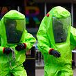 TOPSHOT - Members of the emergency services in green biohazard suits work to afix the tent over the bench where a man and a woman were found on March 4 in critical condition at The Maltings shopping centre in Salisbury, southern England, on March 8, 2018 after the tent became detached. 
British detectives on March 8 scrambled to find the source of the nerve agent used in the "brazen and reckless" attempted murder of a Russian former double-agent and his daughter. Sergei Skripal, 66, who moved to Britain in a 2010 spy swap, is unconscious in a critical but stable condition in hospital along with his daughter Yulia after they collapsed on a bench outside a shopping centre on Sunday.
 / AFP PHOTO / Ben STANSALL
