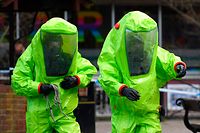 TOPSHOT - Members of the emergency services in green biohazard suits work to afix the tent over the bench where a man and a woman were found on March 4 in critical condition at The Maltings shopping centre in Salisbury, southern England, on March 8, 2018 after the tent became detached. 
British detectives on March 8 scrambled to find the source of the nerve agent used in the "brazen and reckless" attempted murder of a Russian former double-agent and his daughter. Sergei Skripal, 66, who moved to Britain in a 2010 spy swap, is unconscious in a critical but stable condition in hospital along with his daughter Yulia after they collapsed on a bench outside a shopping centre on Sunday.
 / AFP PHOTO / Ben STANSALL