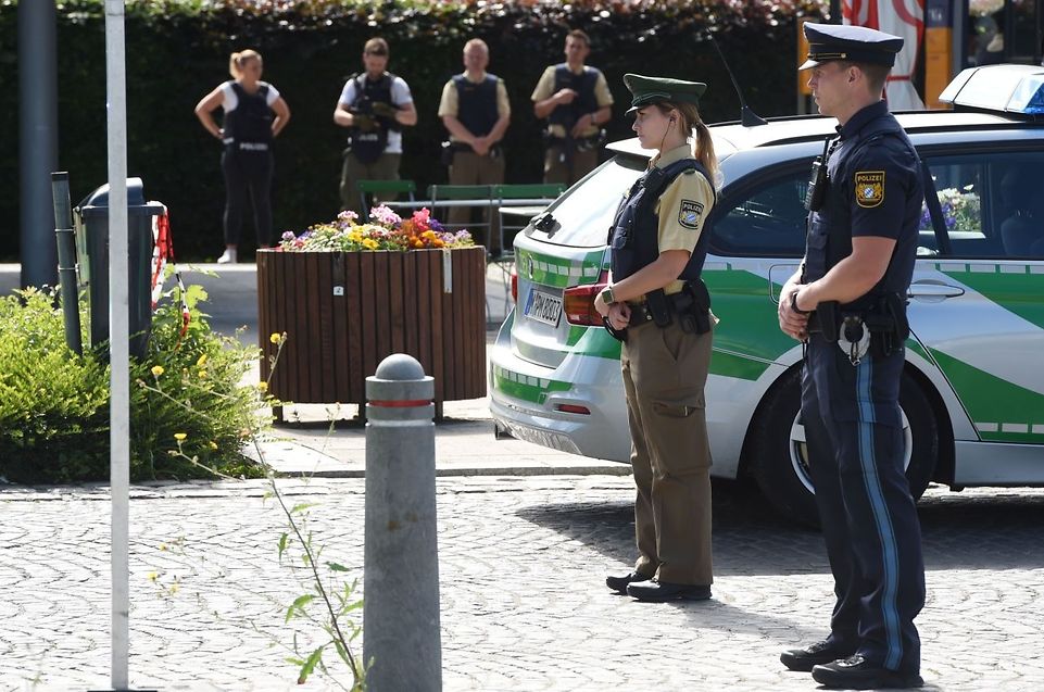 Police officers secure the area around a commuter rail station in Unterfoehring near Munich, southern Germany, where shots were fired on June 13, 2017.