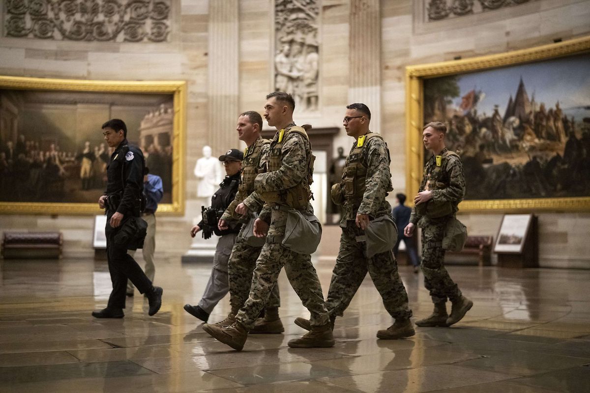 Members of the Marine Corps Chemical Biological Incident Response Force walk through the Capitol Rotunda before U.S. President Joe Biden delivers the State of the Union address on Tuesday